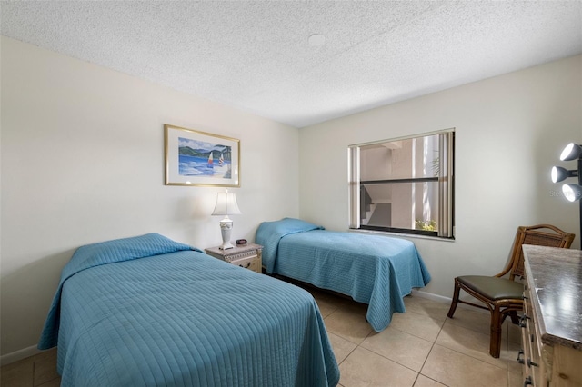 tiled bedroom with a textured ceiling