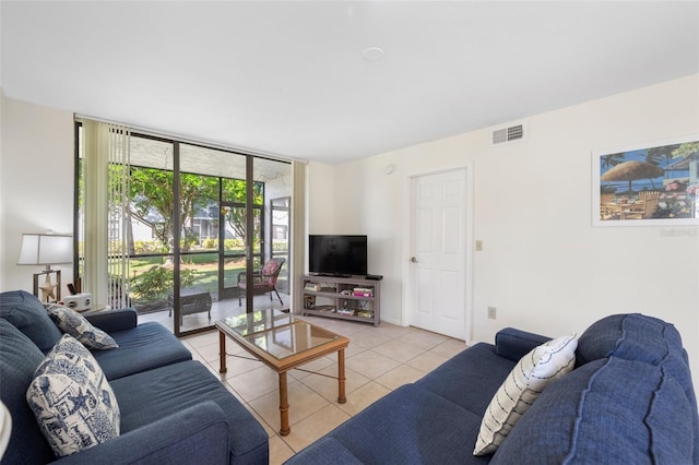 tiled living room with floor to ceiling windows