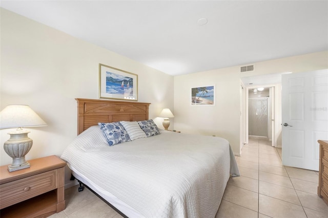 bedroom with light tile patterned floors