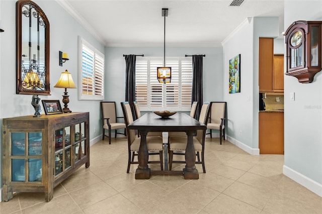 dining room featuring ornamental molding and light tile patterned floors