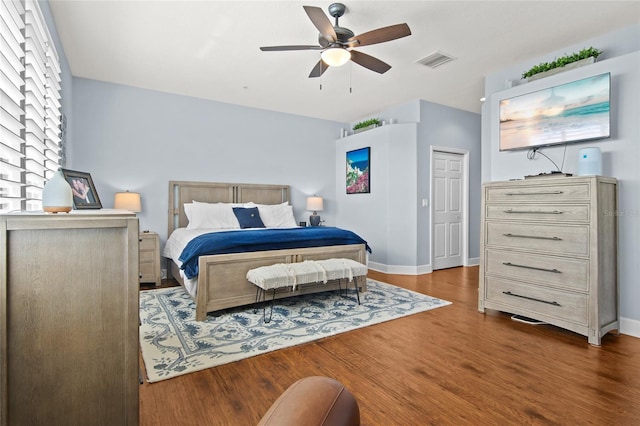 bedroom with dark wood-type flooring and ceiling fan