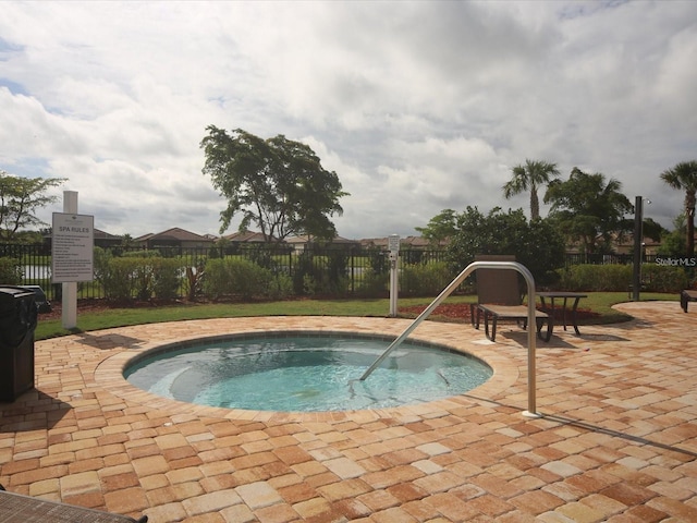 view of pool featuring a hot tub and a patio