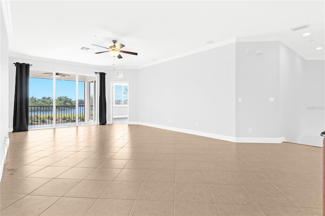 tiled spare room featuring ceiling fan and ornamental molding