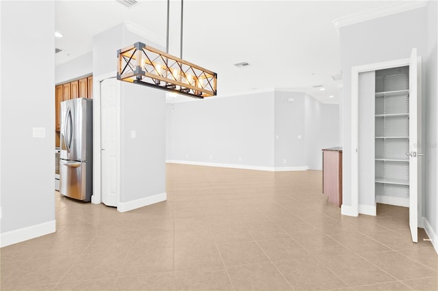 interior space featuring light tile patterned floors and ornamental molding