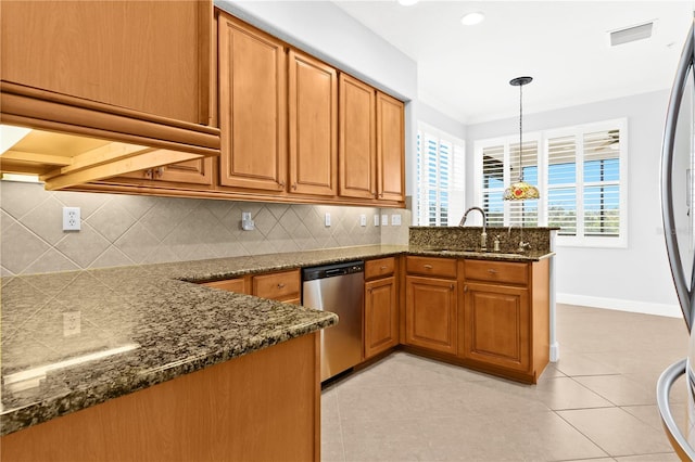 kitchen with decorative light fixtures, tasteful backsplash, sink, stainless steel dishwasher, and kitchen peninsula