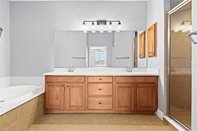 bathroom featuring tile patterned flooring, vanity, and separate shower and tub