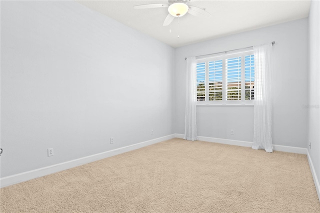 unfurnished room with light colored carpet and ceiling fan