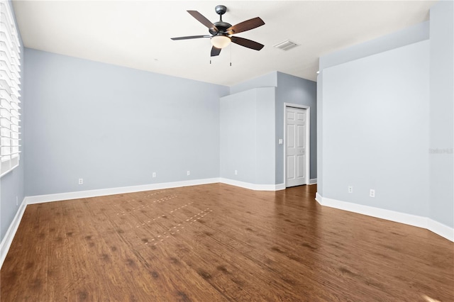 empty room with dark wood-type flooring and ceiling fan