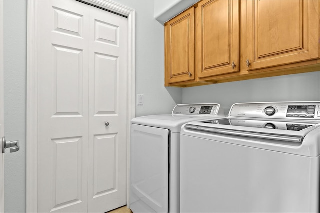 laundry room featuring cabinets and washing machine and clothes dryer