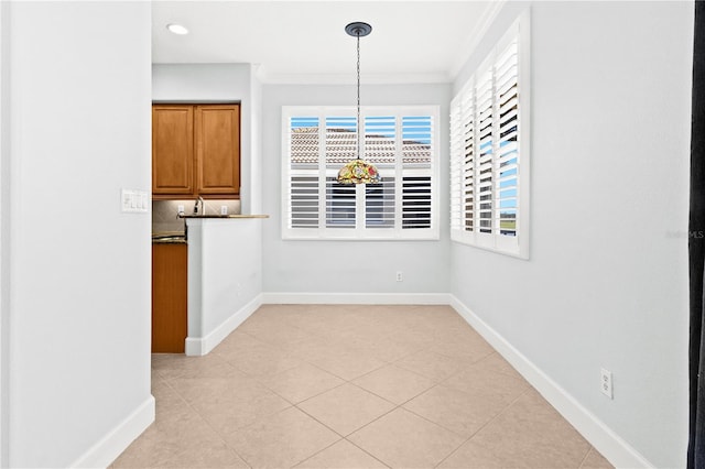 unfurnished dining area featuring light tile patterned flooring and ornamental molding