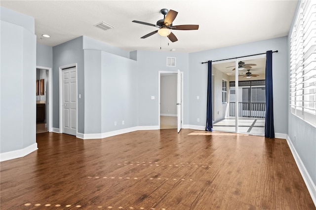 unfurnished room with dark hardwood / wood-style flooring and ceiling fan