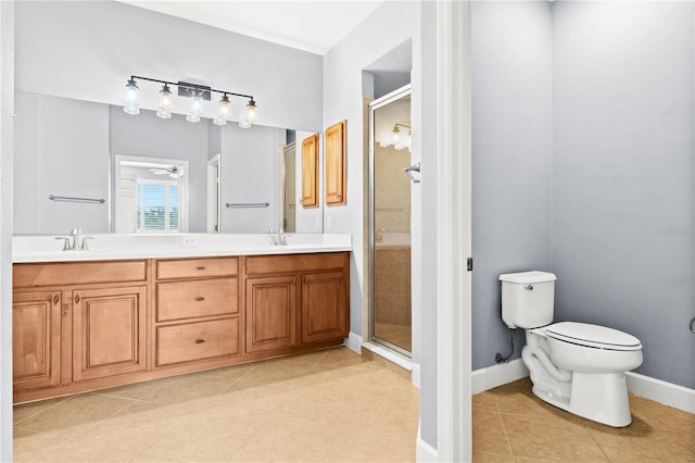 bathroom featuring tile patterned flooring, walk in shower, vanity, and toilet