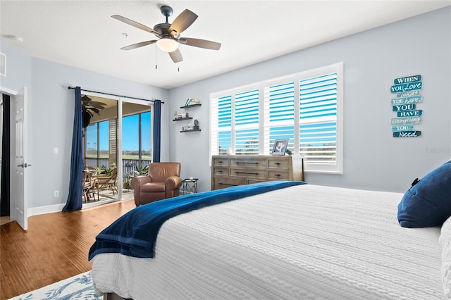 bedroom with access to exterior, wood-type flooring, and ceiling fan