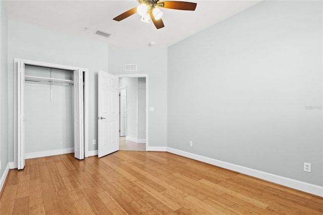 unfurnished bedroom featuring a closet, ceiling fan, and light hardwood / wood-style flooring