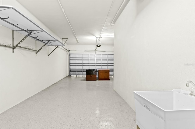 garage featuring sink and a garage door opener