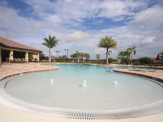 view of swimming pool featuring a patio and pool water feature