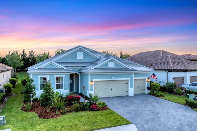 view of front of property featuring a lawn and a garage