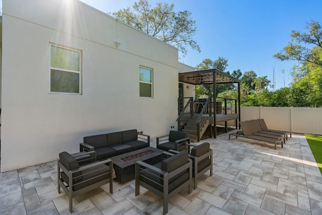 view of patio / terrace with an outdoor living space with a fire pit and a wooden deck