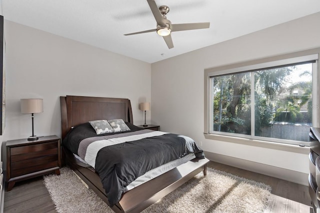 bedroom with ceiling fan and dark hardwood / wood-style flooring