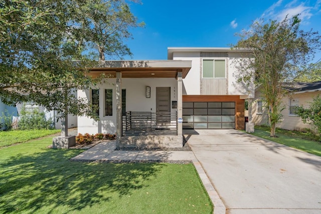 contemporary home featuring a front yard and a garage