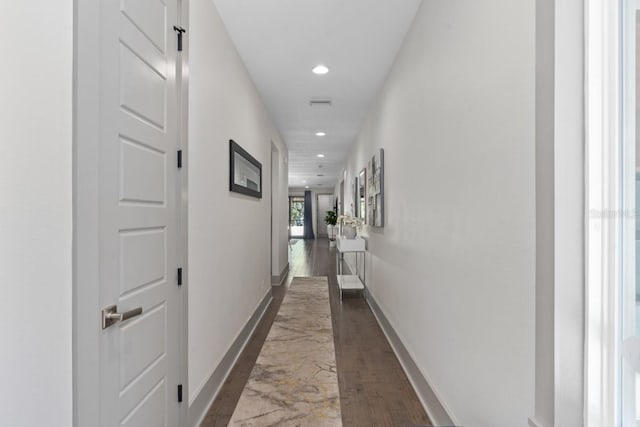 corridor featuring dark hardwood / wood-style floors