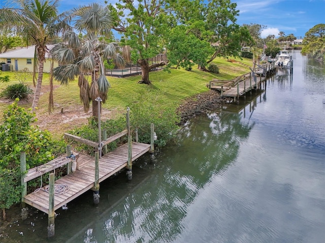 dock area featuring a yard and a water view