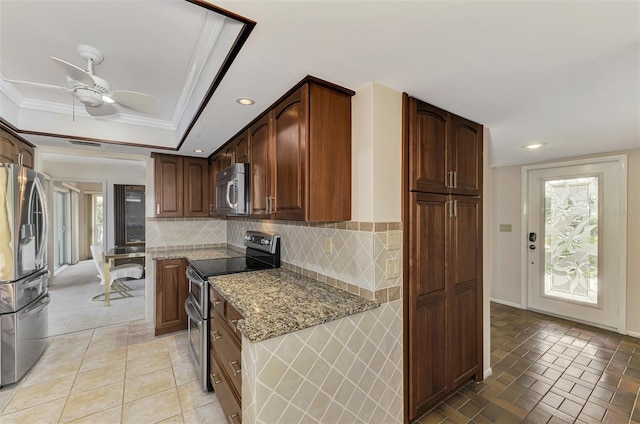 kitchen featuring stone counters, ceiling fan, stainless steel appliances, decorative backsplash, and ornamental molding