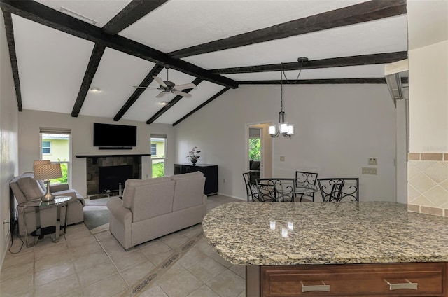 living room with a fireplace, ceiling fan with notable chandelier, lofted ceiling with beams, and light tile patterned flooring