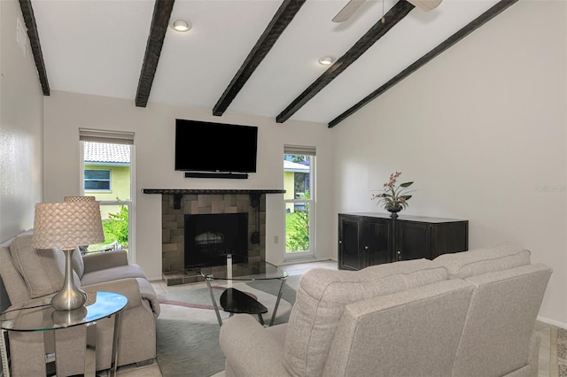 living room with lofted ceiling with beams, ceiling fan, and a wealth of natural light