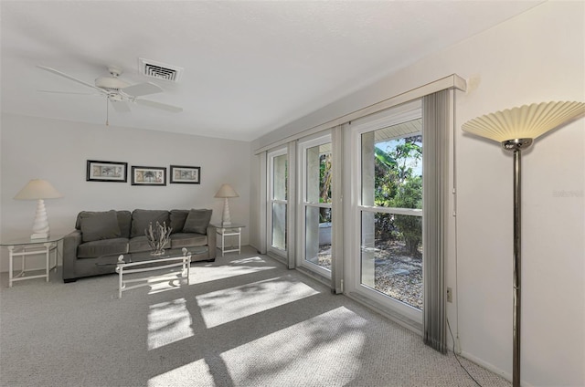 living room featuring ceiling fan and carpet floors