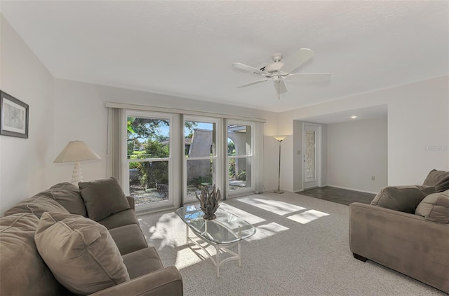 living room with ceiling fan and carpet floors