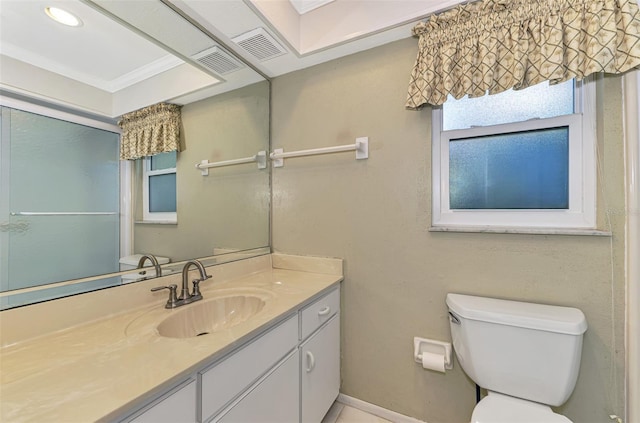 bathroom with vanity, crown molding, and toilet