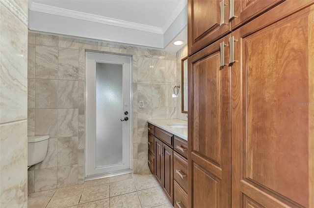 bathroom with ornamental molding, tile walls, vanity, and toilet