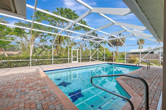 view of swimming pool with a lanai and a patio