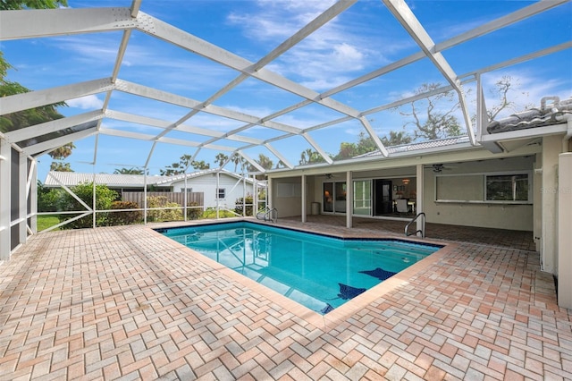 view of pool with a patio area, ceiling fan, and a lanai