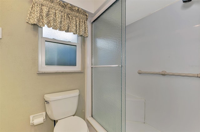 bathroom with walk in shower and toilet