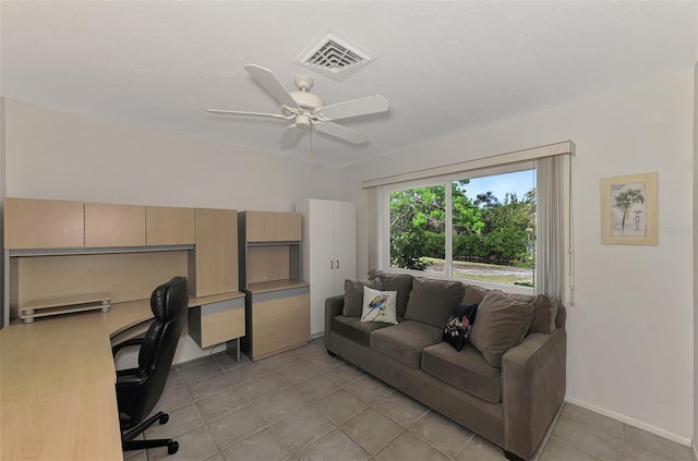 office featuring light tile patterned floors, a textured ceiling, and ceiling fan