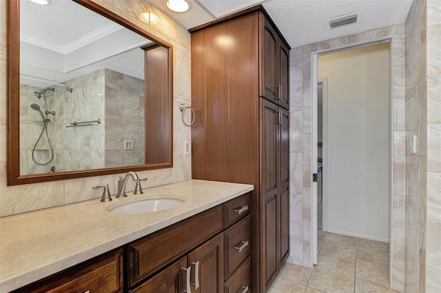 bathroom featuring vanity, tile patterned flooring, and ornamental molding