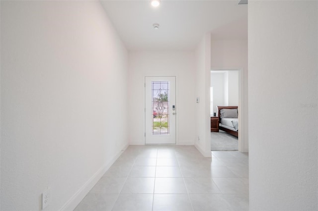 doorway to outside with light tile patterned floors