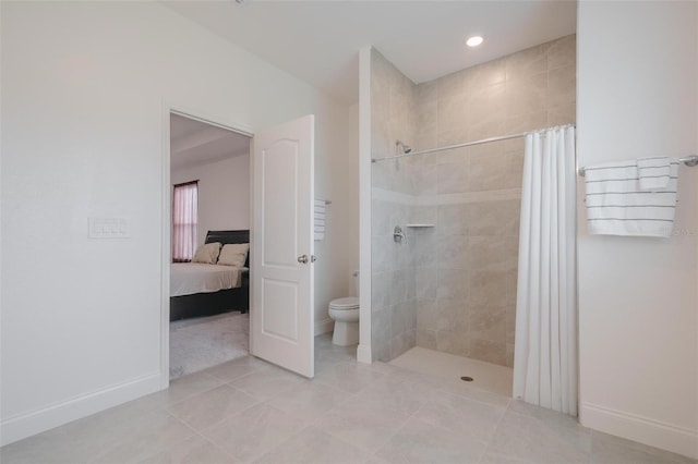 bathroom featuring tile patterned floors, toilet, and walk in shower