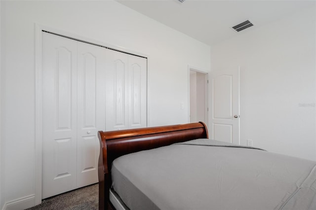 bedroom featuring a closet and dark carpet