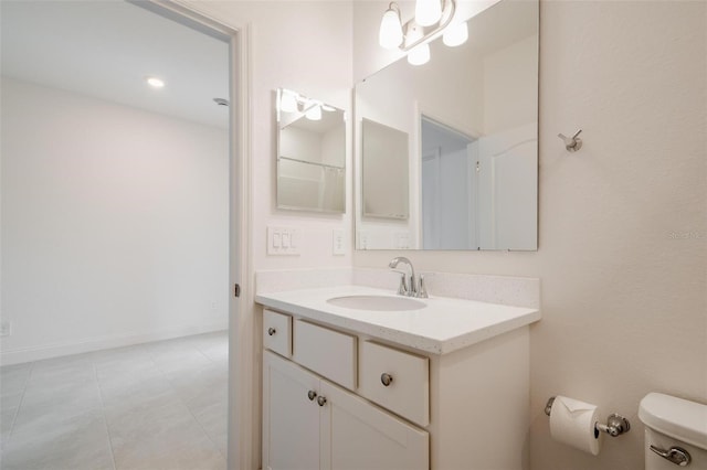 bathroom with tile patterned floors, vanity, and toilet