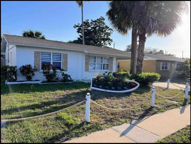 ranch-style house with a front lawn