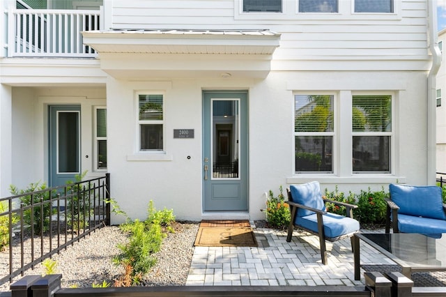 entrance to property with a patio area and a balcony