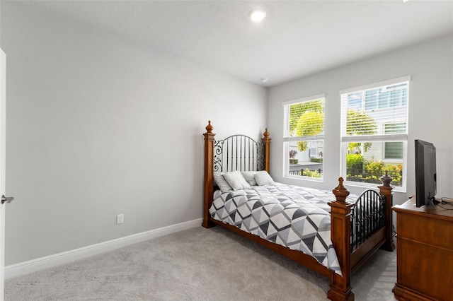 bedroom featuring baseboards and carpet flooring