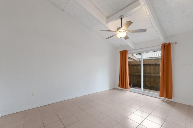 empty room featuring vaulted ceiling with beams, ceiling fan, light tile patterned floors, and a textured ceiling