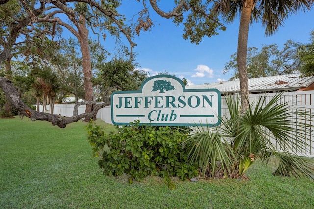 community / neighborhood sign with a yard