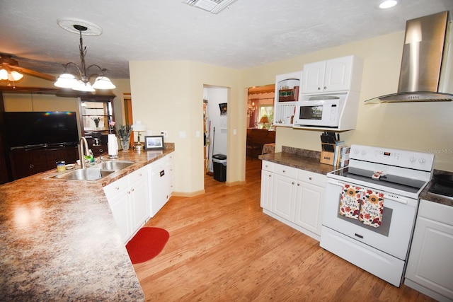 31730 Clay Gully Rd, Myakka City, FL 34251 - kitchen with white appliances, wall chimney range hood, a sink, white cabinetry, and light wood-style floors