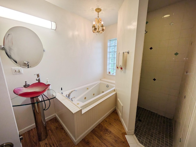 31730 Clay Gully Rd, Myakka City, FL 34251 - full bath with wood finished floors, tiled shower, a whirlpool tub, a chandelier, and baseboards
