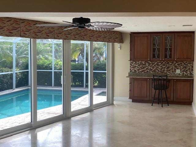 doorway to outside featuring ceiling fan